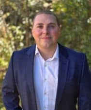 Professional portrait of a man in a suit outdoors for ClearBridge Tech.