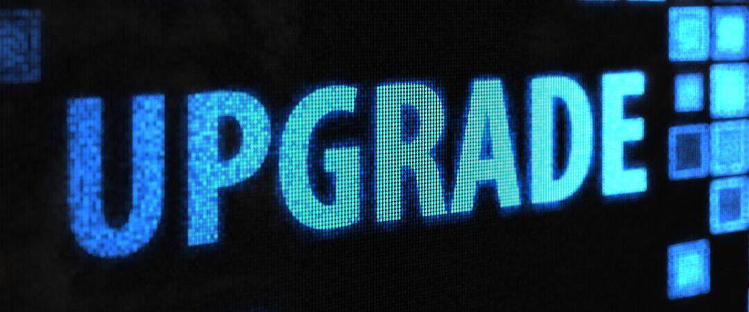 Digital upgrade concept with the word 'UPGRADE' in blue pixels.